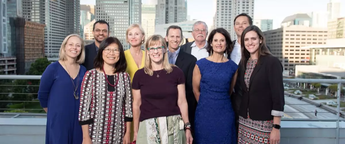 Group photo of the 2019 Renaissance Board standing outdoors with a city skyline behind them